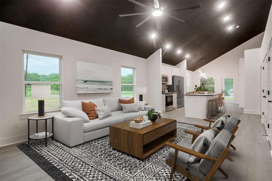 Living room featuring ceiling fan, high vaulted ceiling, light wood-style flooring, plenty of natural light, and recessed lighting