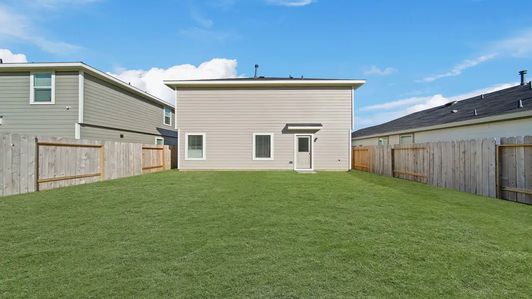 Exterior details and patio area of a home in The Canopies, Splendora (Image 3).