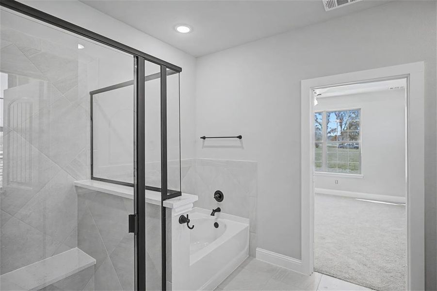 Full bath with a garden tub, a stall shower, light colored carpet, and light tile patterned flooring