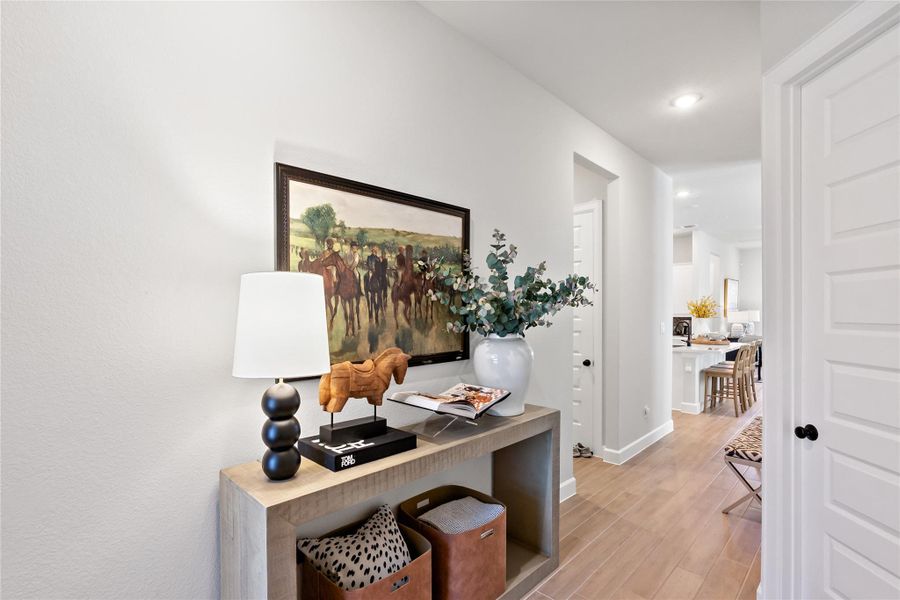 Hall with light wood-style flooring and recessed lighting