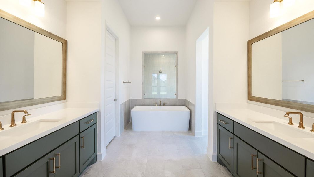 Full bathroom featuring a soaking tub, a walk in shower, two vanities, light tile patterned flooring, and recessed lighting Full bathroom featuring a soaking tub, a walk in shower, two vanities, light tile patterned flooring, and recessed lighting