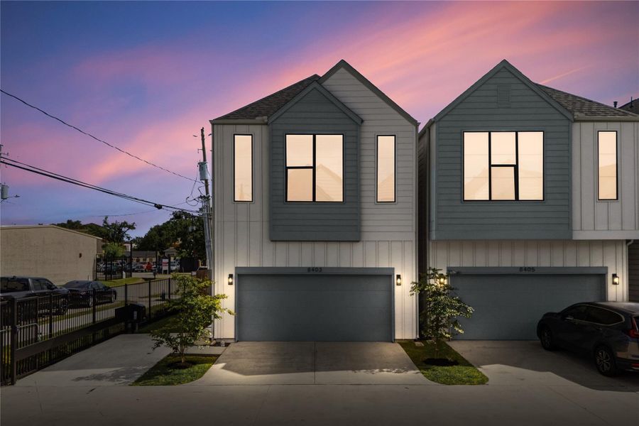 Twilight views highlight the clean lines and cohesive design of this gated community in Spring Branch.