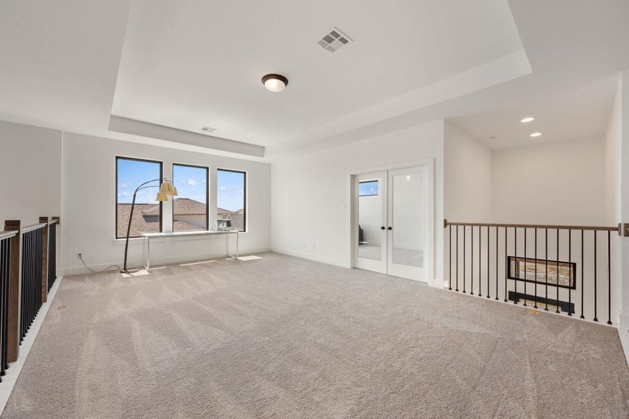 A spacious upper-level bonus room awaits, offering ample natural light through large windows and a versatile layout. A spacious upper-level bonus room awaits, offering ample natural light through large windows and a versatile layout.
