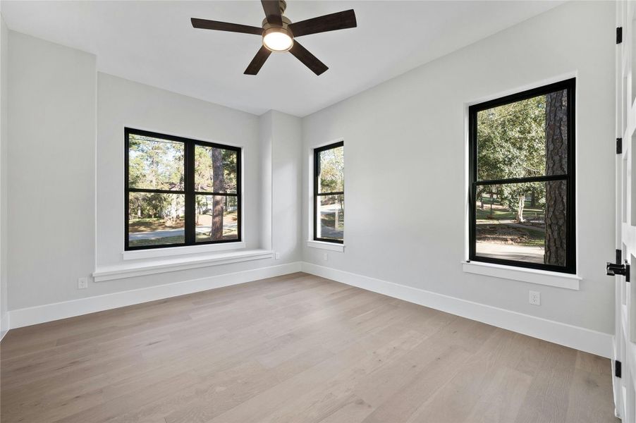 Spare room featuring ceiling fan and light wood-type flooring