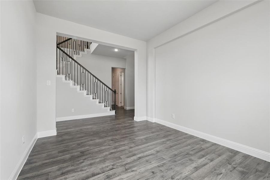 Kitchen featuring a sink, baseboards, dark wood-style flooring, ceiling fan, and a high ceiling Kitchen featuring a sink, baseboards, dark wood-style flooring, ceiling fan, and a high ceiling