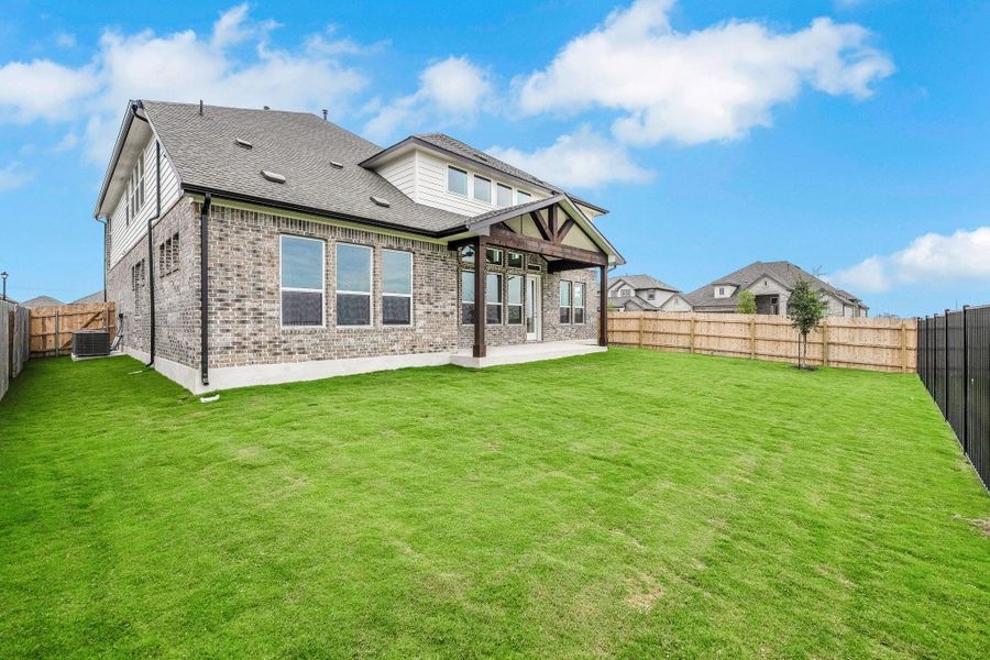 Back of house featuring brick siding, a patio, roof with shingles, and a fenced backyard Back of house featuring brick siding, a patio, roof with shingles, and a fenced backyard