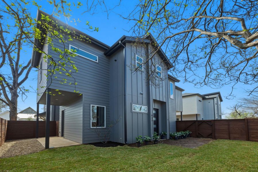 Rear view of property with a fenced backyard, board and batten siding, and a gate