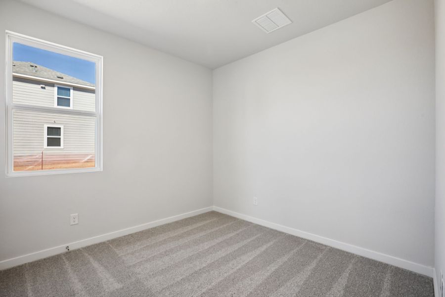 A room with a window and a rug. A room with a window and a rug.