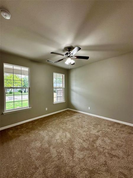 Carpeted empty room with ceiling fan