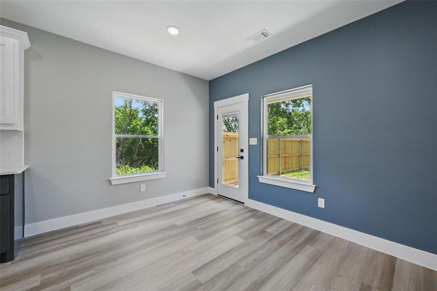 Unfurnished living room featuring plenty of natural light, light wood finished floors, baseboards, and recessed lighting