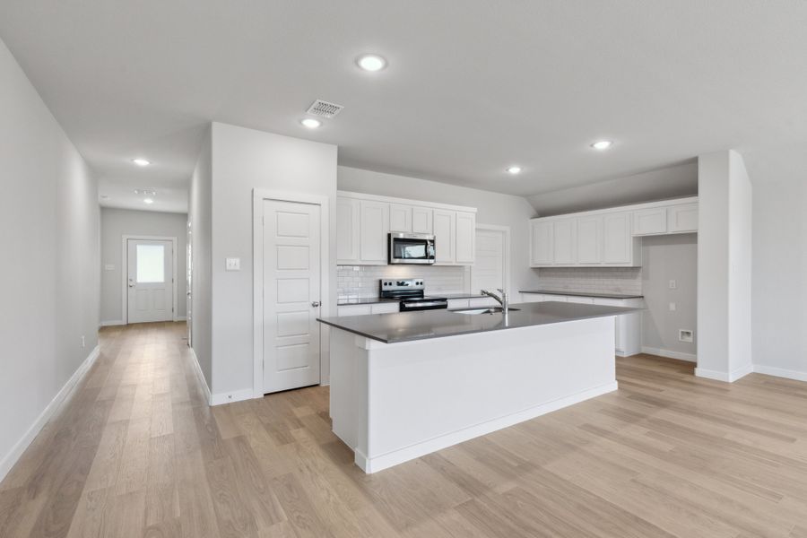 Kitchen in the Harrison home plan by Trophy Signature Homes – REPRESENTATIVE PHOTO