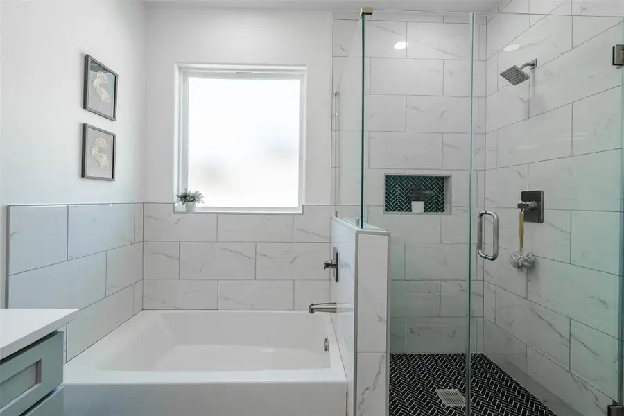 Full bath with vanity, a bath, and a stall shower