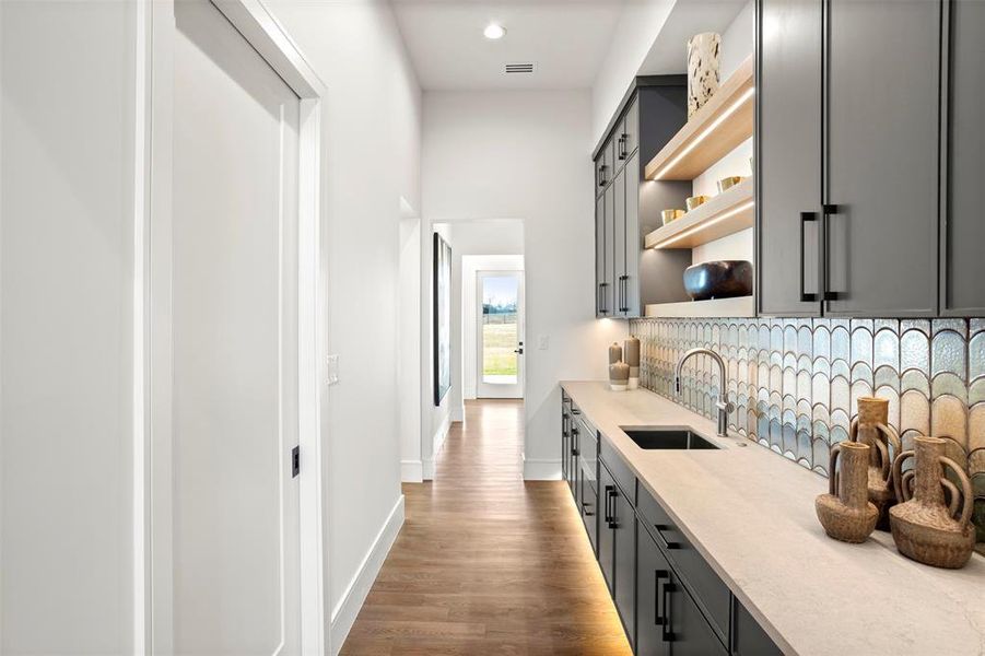 Another view of the prep-kitchen with door to outdoor grill area.