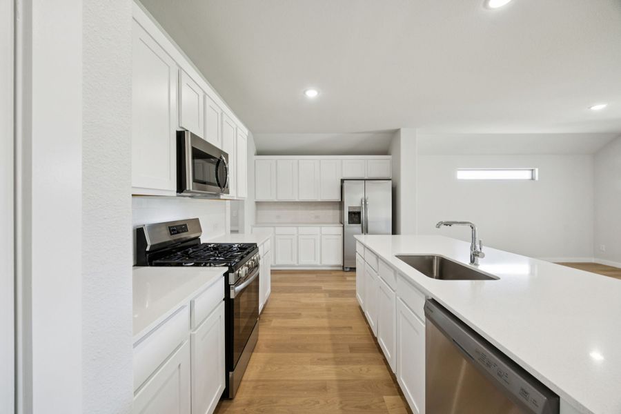 Kitchen in the Heisman home plan by Trophy Signature Homes – REPRESENTATIVE PHOTO Kitchen in the Heisman home plan by Trophy Signature Homes – REPRESENTATIVE PHOTO