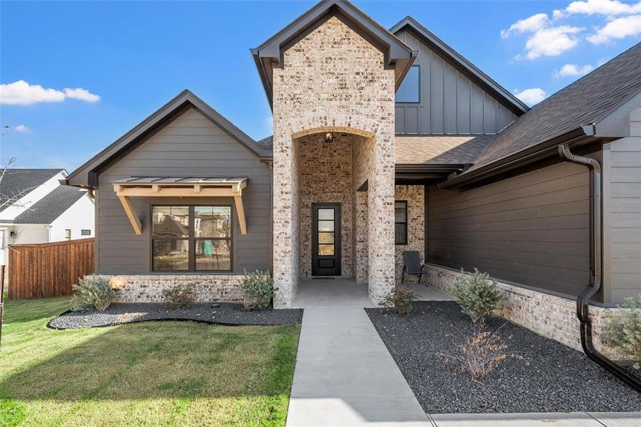View of front of property featuring board and batten siding and brick siding View of front of property featuring board and batten siding and brick siding