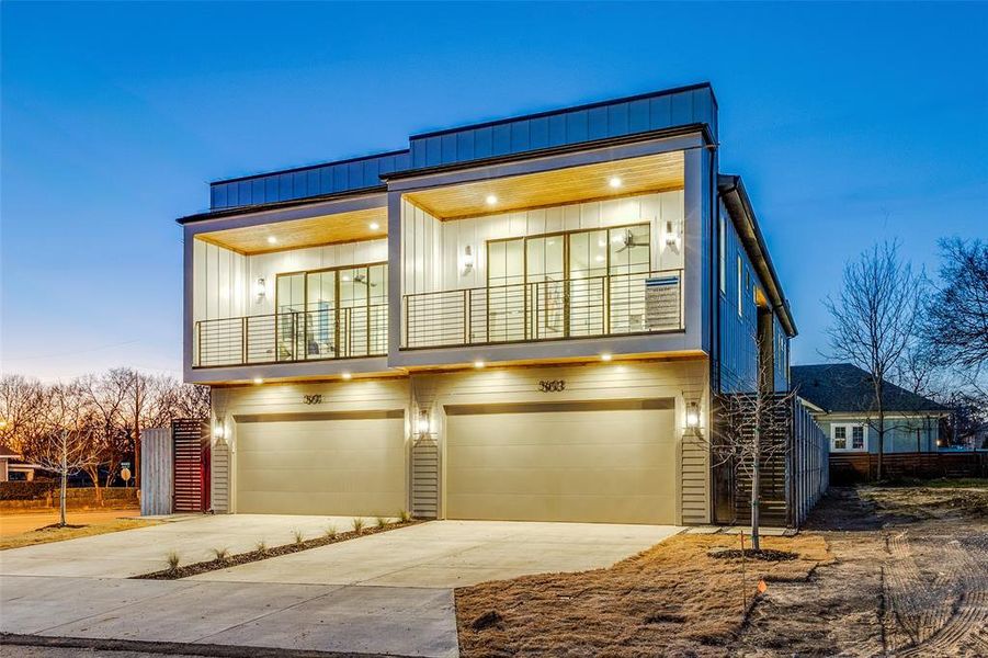 View of front of house with driveway, a balcony, an attached garage, and board and batten siding