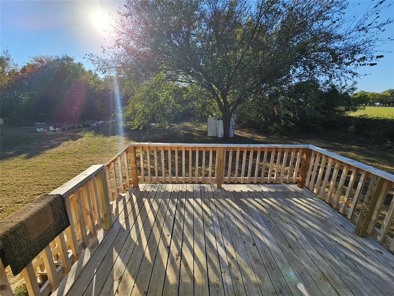 Wooden deck featuring a yard Wooden deck featuring a yard