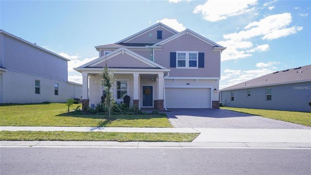 Front exterior of a new home in , Davenport, FL, highlighting curb appeal (Image 1). Front exterior of a new home in , Davenport, FL, highlighting curb appeal (Image 1).
