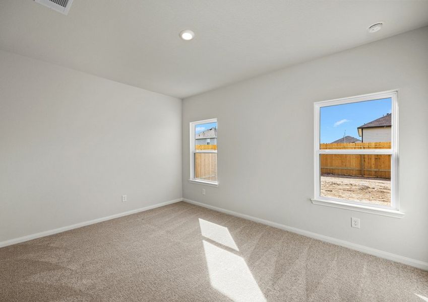 Master bedroom with two windows and lush carpet flooring Master bedroom with two windows and lush carpet flooring