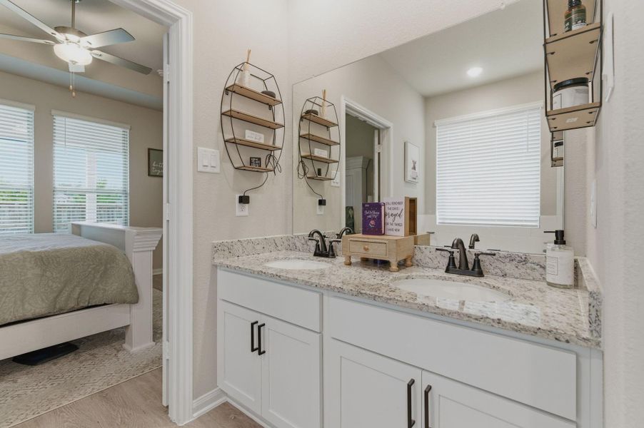 Primary bath with dual sink area with granite countertops