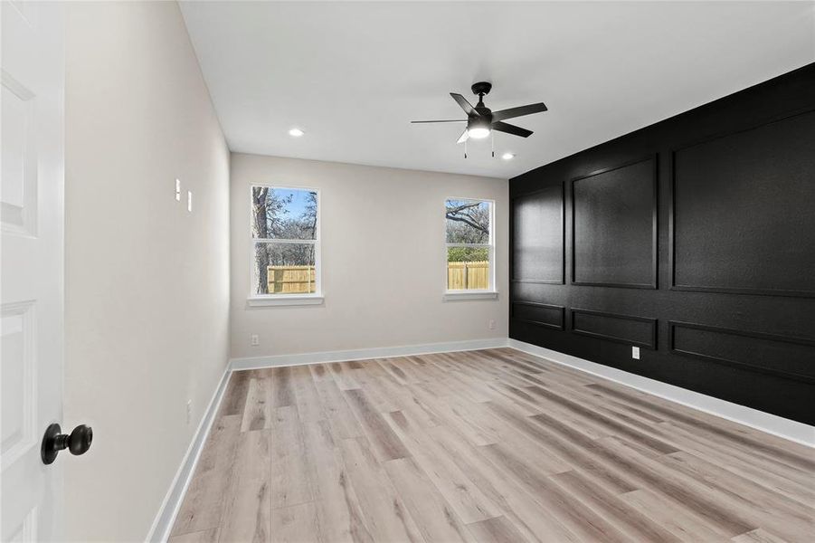 Spare room with light wood-type flooring and ceiling fan