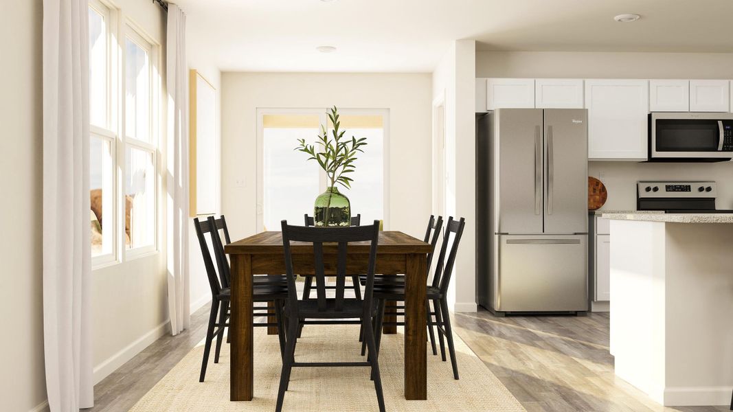 A dining room with a table and chairs.