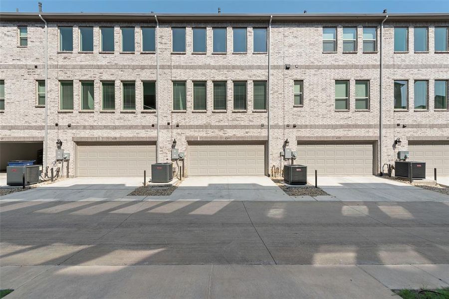 Front exterior of a new home in Wade Settlement Townhomes, Frisco, TX, highlighting curb appeal (Image 1).