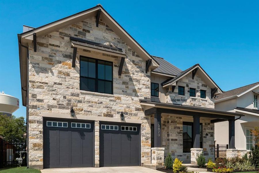 View of front of home featuring an attached garage and stone siding View of front of home featuring an attached garage and stone siding