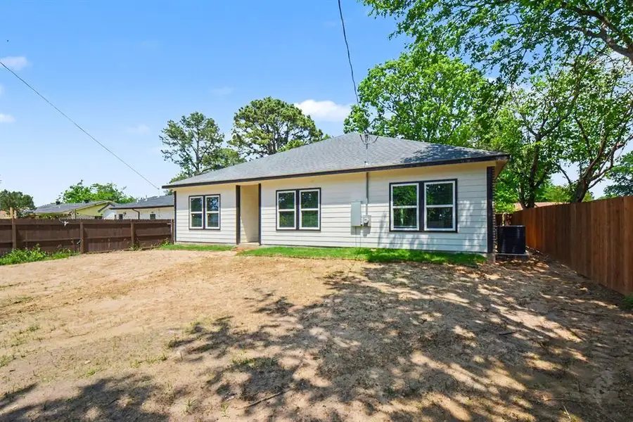 The property features a ranch-style exterior with light-colored siding and a dark roof