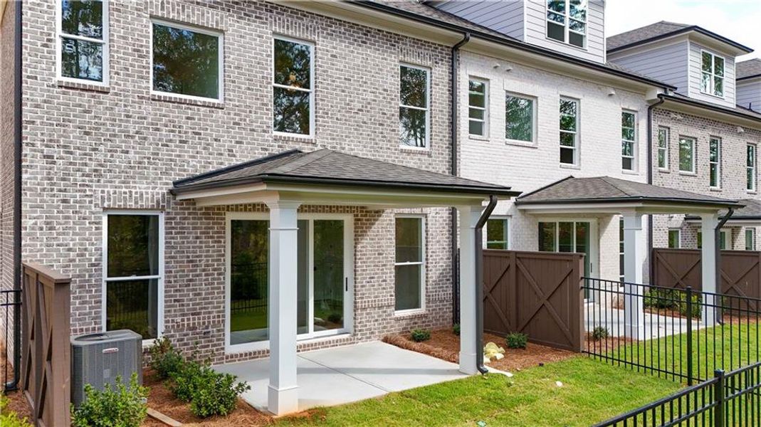 Exterior details and patio area of a home in Ward's Crossing Townhomes, Johns Creek (Image 24).