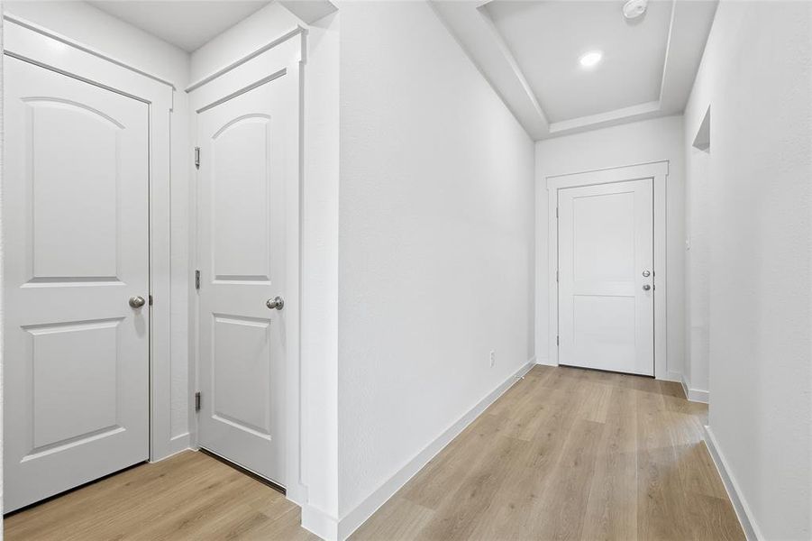 Hallway featuring light wood-style floors