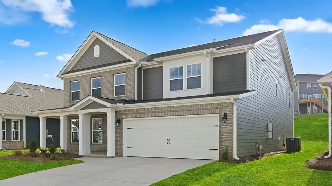 Front exterior of a new home in Spring Ridge Reserve, Anderson, SC, highlighting curb appeal (Image 2). Front exterior of a new home in Spring Ridge Reserve, Anderson, SC, highlighting curb appeal (Image 2).