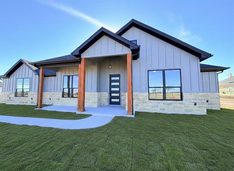 Modern farmhouse with board and batten siding, cedar entry posts, and a wonderful covered porch to sit and drink morning coffee