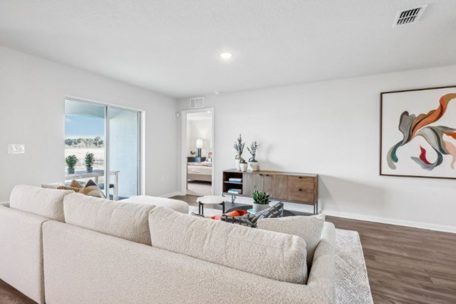 A living room with a couch and a table. A living room with a couch and a table.