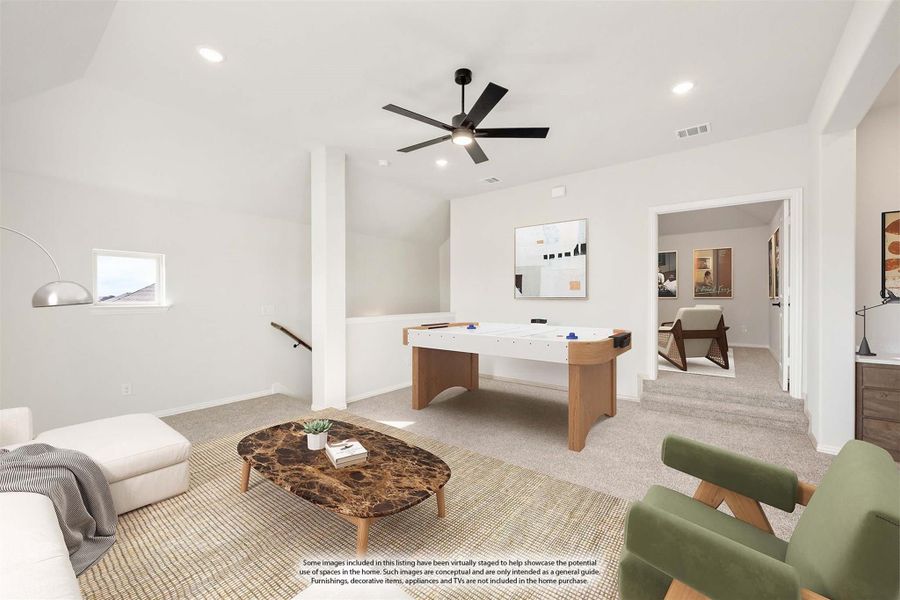 Upstairs game room with air hockey table, ceiling fan, carpet flooring, and open loft layout