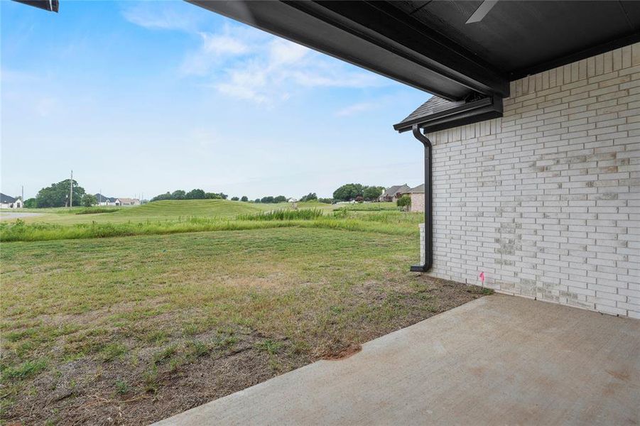 View of grassy yard with a patio View of grassy yard with a patio