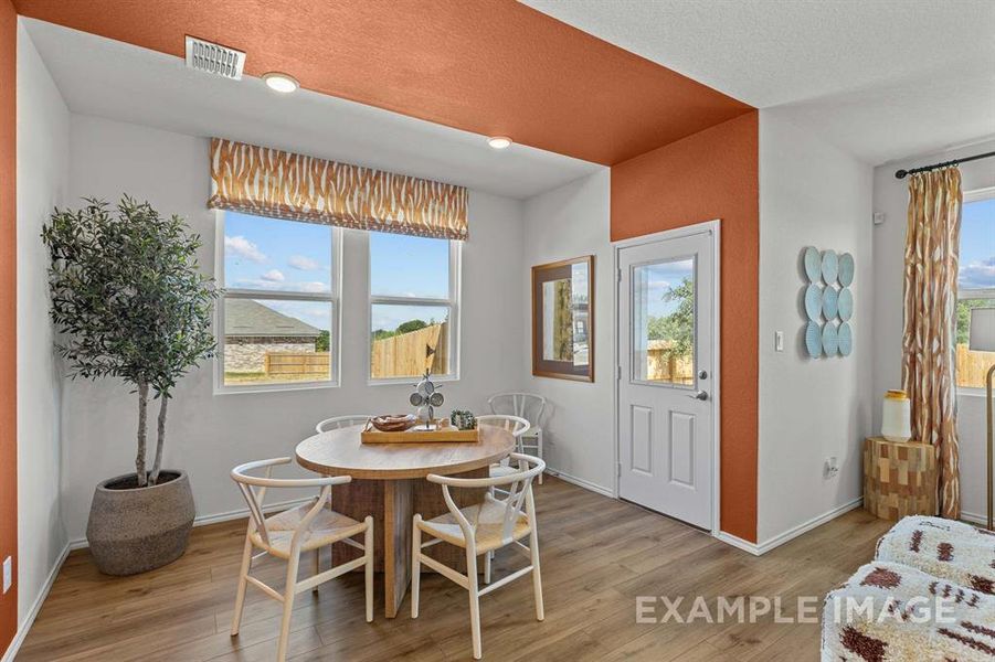 Dining area with a healthy amount of sunlight and light wood-type flooring