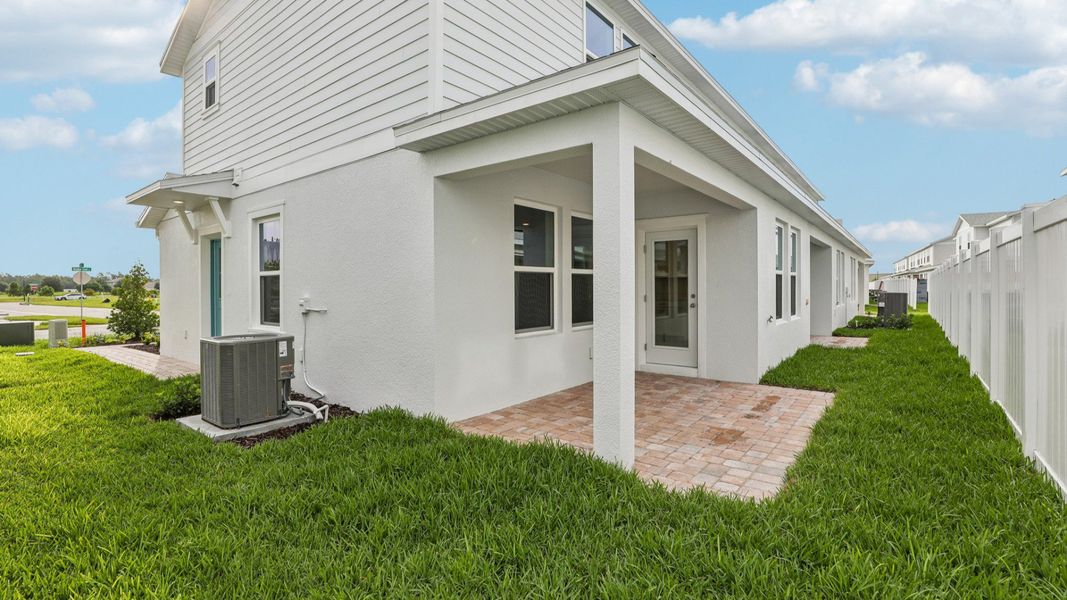 Exterior details and patio area of a home in Cyrene at Harmony, St. Cloud (Image 22).