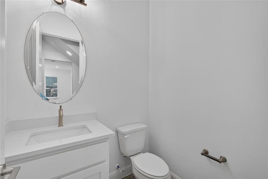 Bathroom vanity with an integrated sink, white cabinetry, and brushed nickel hardware Bathroom vanity with an integrated sink, white cabinetry, and brushed nickel hardware