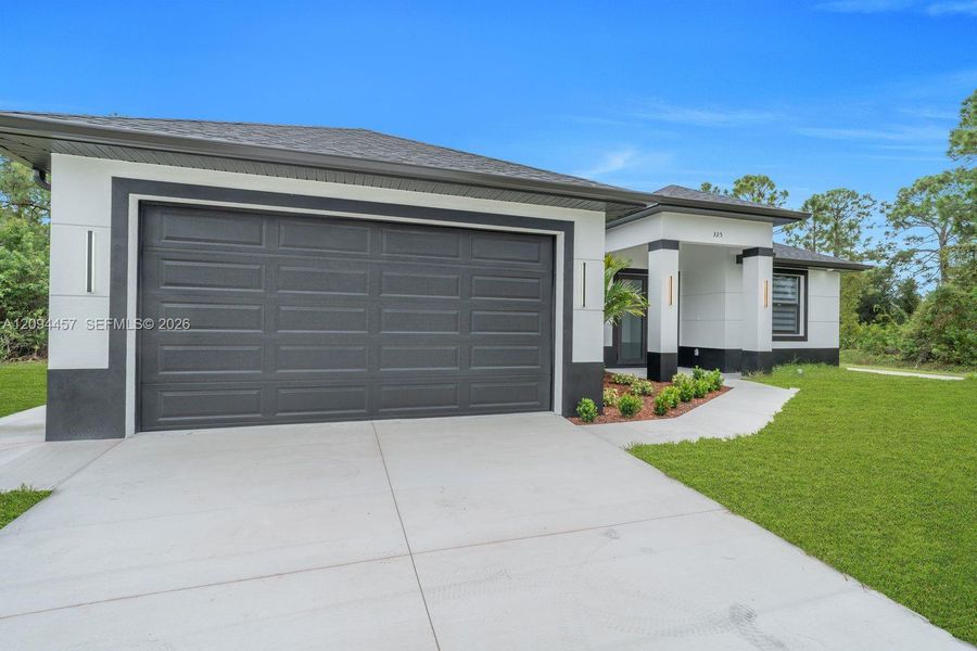Front exterior of a new home in , Lehigh Acres, FL, highlighting curb appeal (Image 2). Front exterior of a new home in , Lehigh Acres, FL, highlighting curb appeal (Image 2).