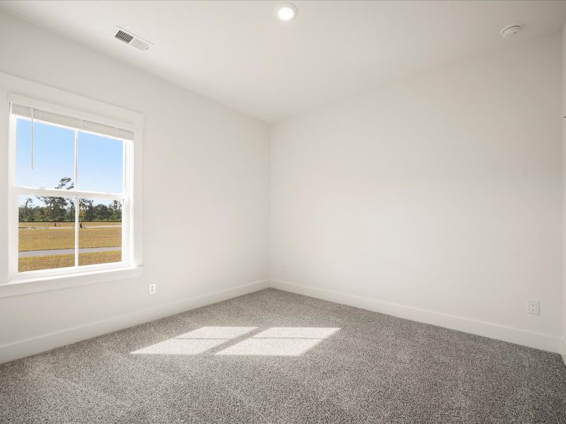 Spacious, unfurnished interior of a new home in The Coves at Lakes of Cane Bay, Summerville (Image 17).