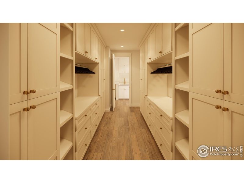 Fully customized primary closet with built in storage and cabinet lighting.