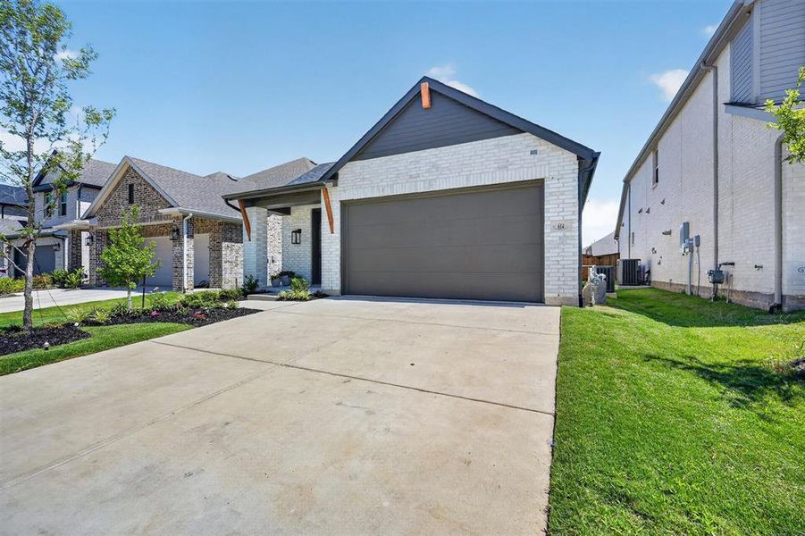 Front exterior of a new home in Heritage Ranch, Sherman, TX, highlighting curb appeal (Image 2).