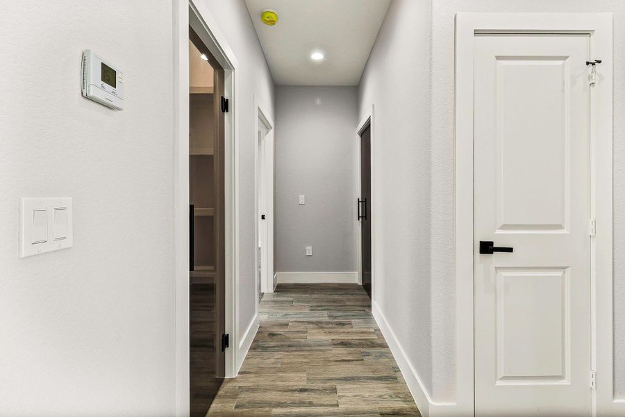 Hallway with access to pantry with glass door. Hallway with access to pantry with glass door.