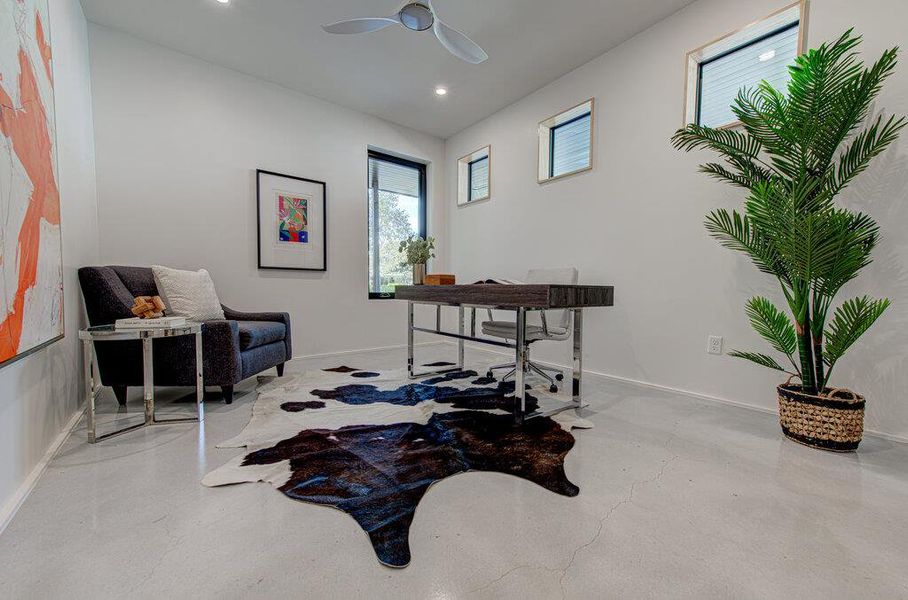 Home office featuring recessed lighting, ceiling fan, finished concrete flooring, and baseboards