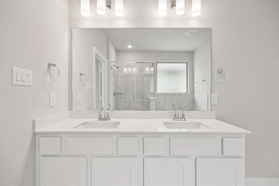 Full bath with a textured wall, double vanity, and a stall shower Full bath with a textured wall, double vanity, and a stall shower