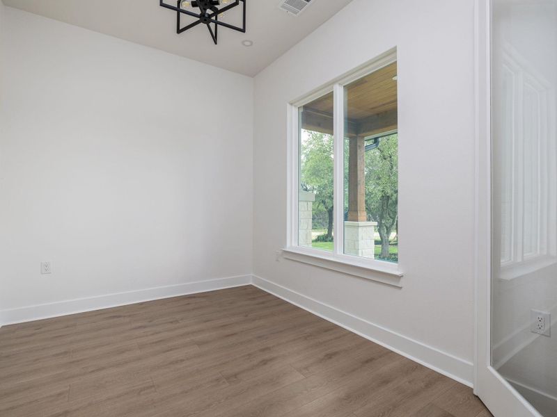 Study with glass doors and large windows that bring in natural lighting Study with glass doors and large windows that bring in natural lighting