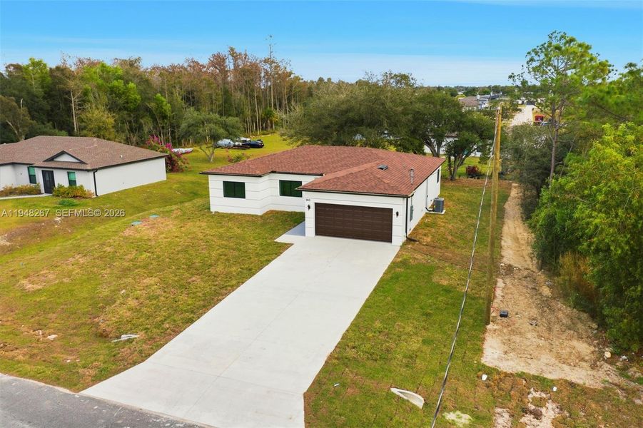 Front exterior of a new home in , Fort Myers, FL, highlighting curb appeal (Image 1). Front exterior of a new home in , Fort Myers, FL, highlighting curb appeal (Image 1).
