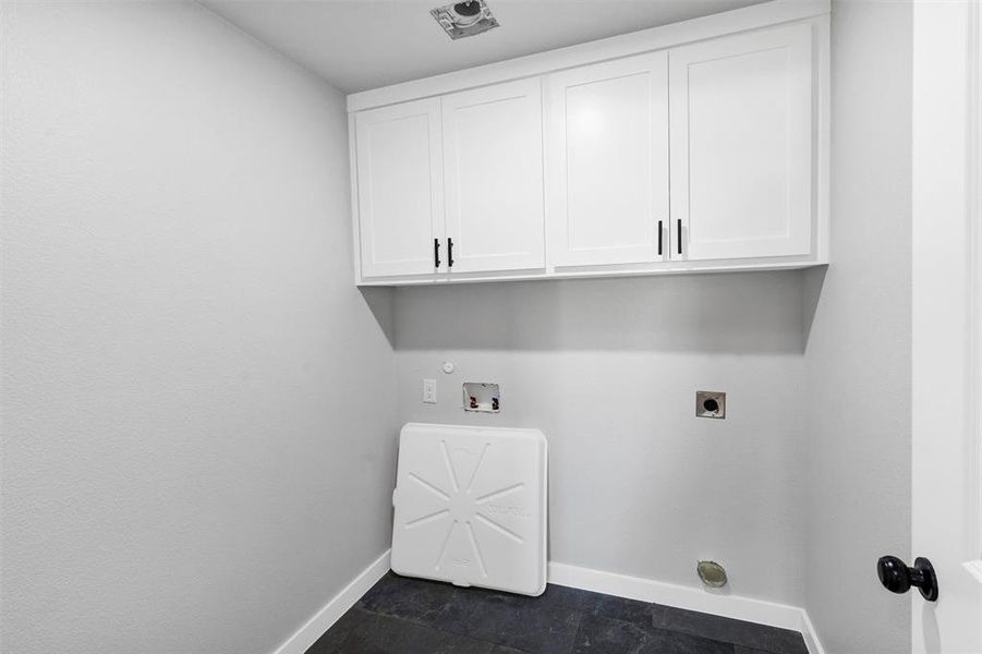 Laundry area with hookup for an electric dryer, baseboards, cabinet space, and hookup for a washing machine
