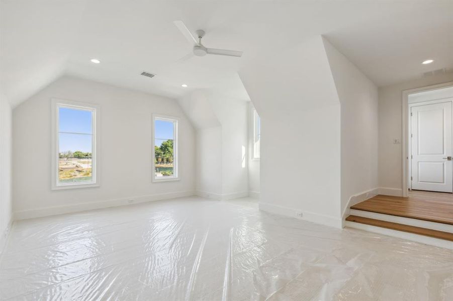 Bonus room featuring vaulted ceiling, and ceiling fan